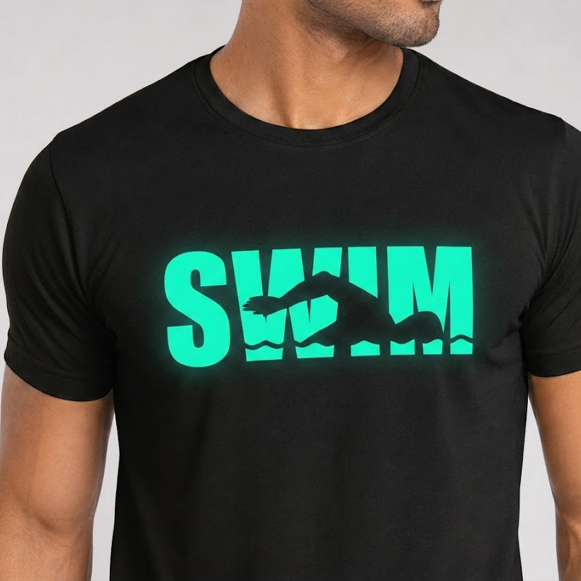 Black t-shirt with green 'SWIM' graphic on a plain background