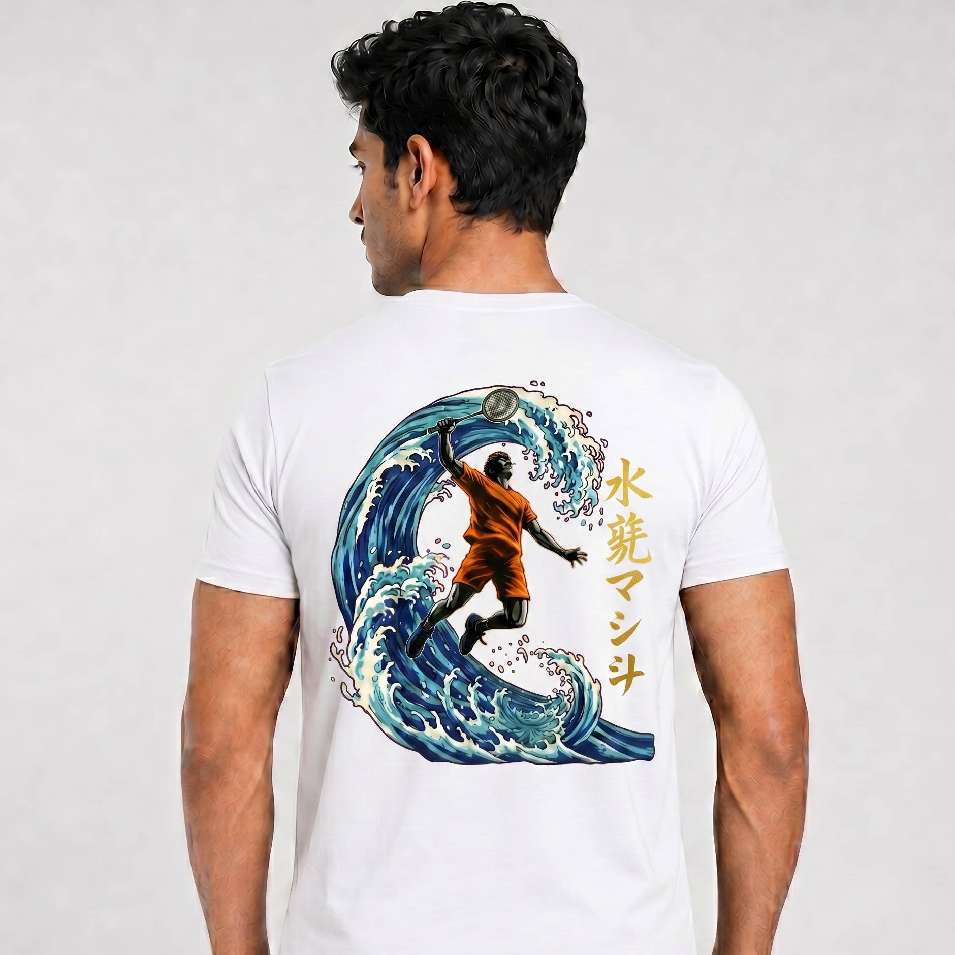 Person wearing a white t-shirt with a graphic design on the back, featuring a surfer and wave.