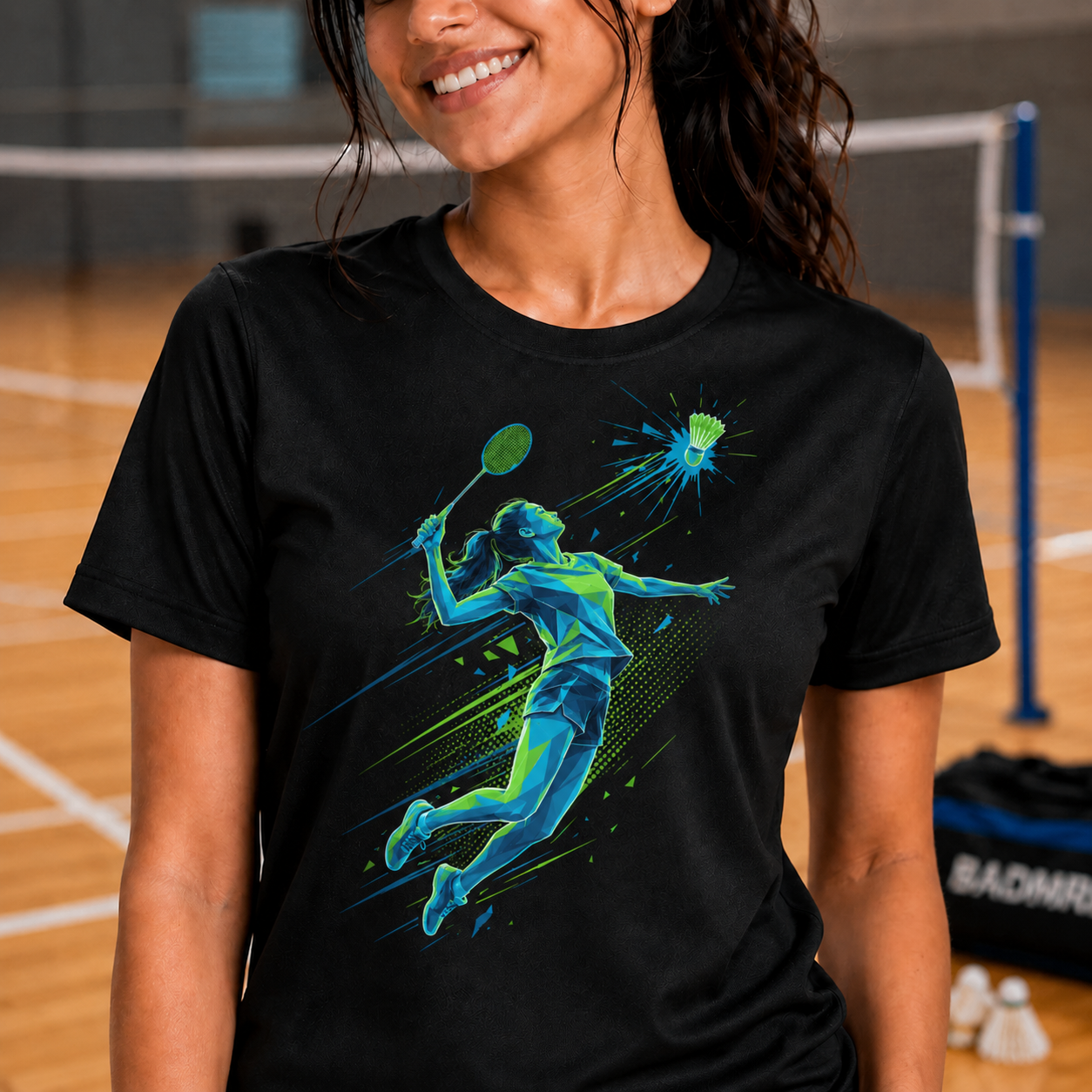 Woman wearing a black t-shirt with a badminton graphic design of a badminton player on an indoor court.