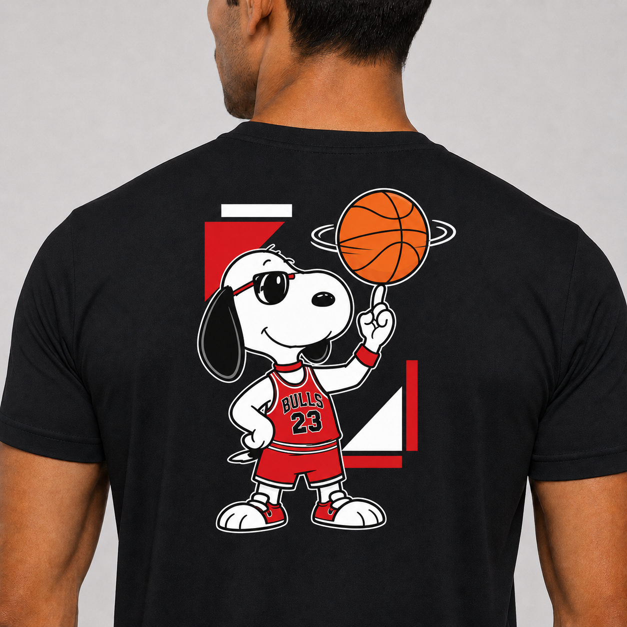 Black t-shirt with a cartoon character holding a basketball on the back, against a plain background.