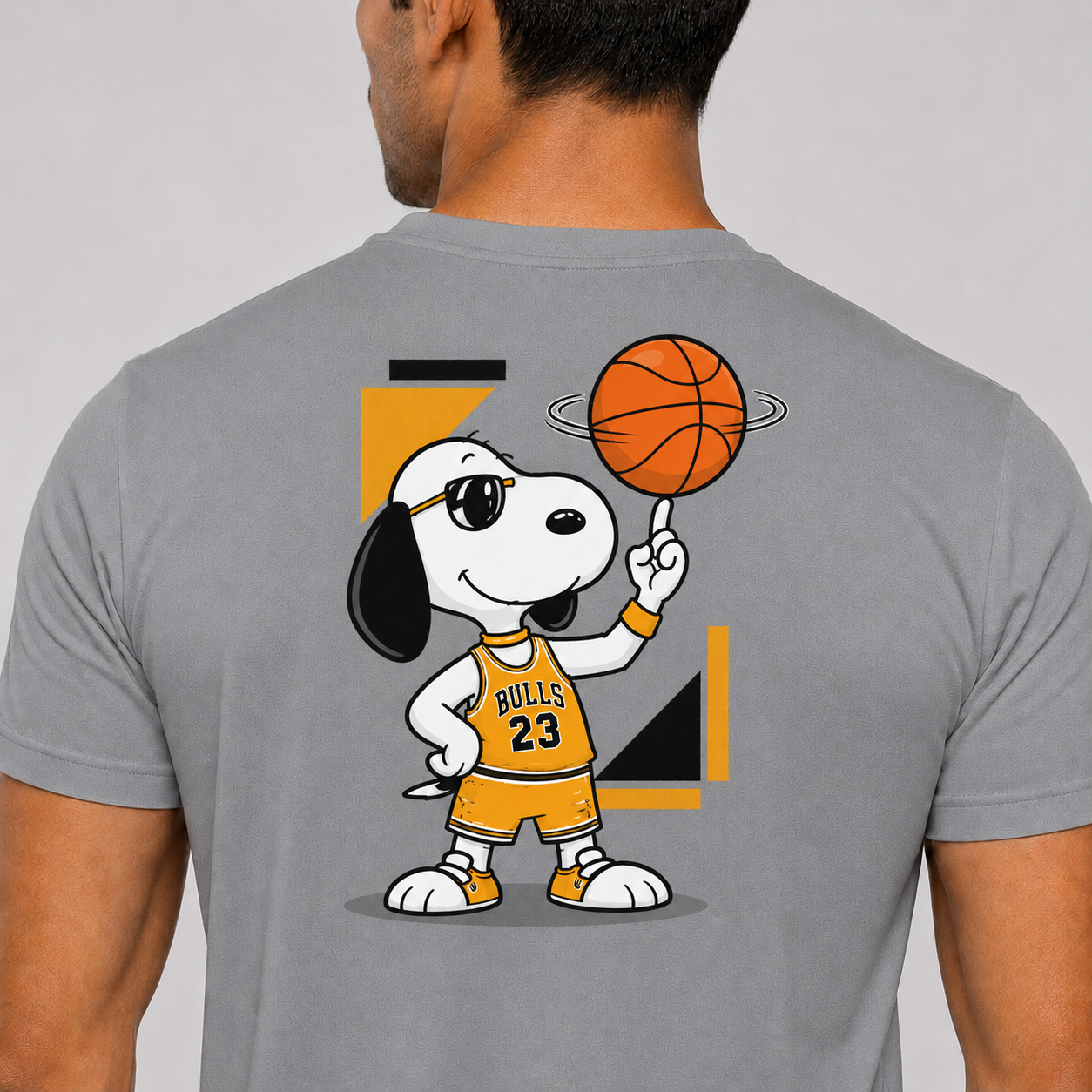 Gray t-shirt with a cartoon character holding a basketball on the back, against a plain background.
