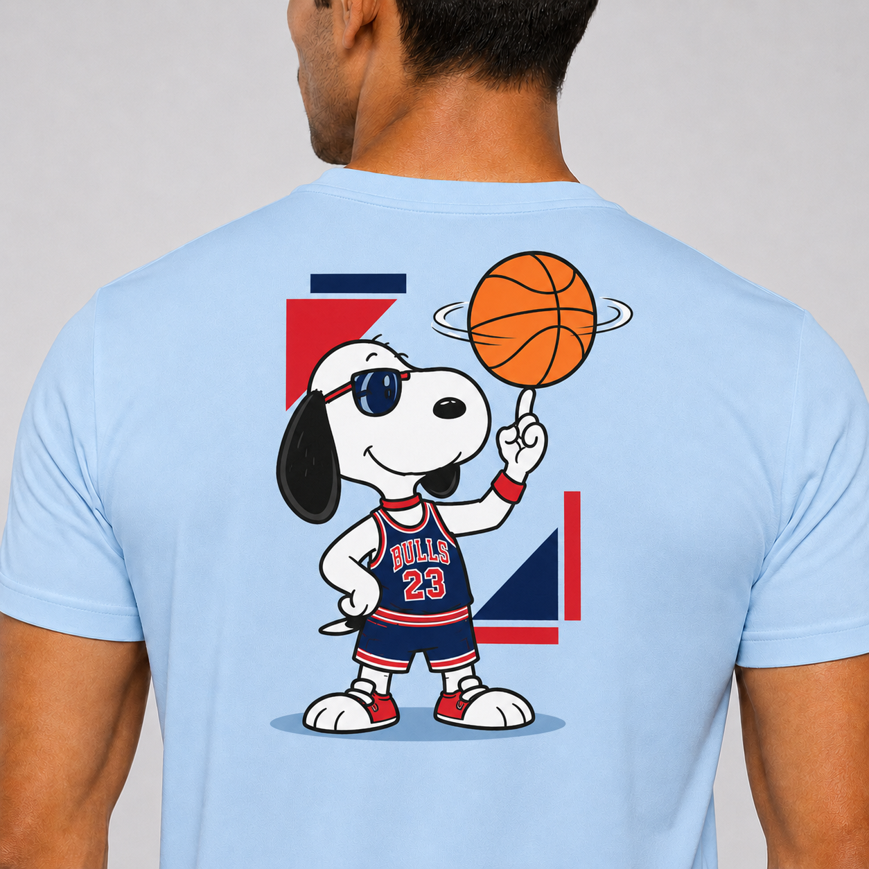 Light blue t-shirt with a cartoon character holding a basketball on the back, against a plain background.