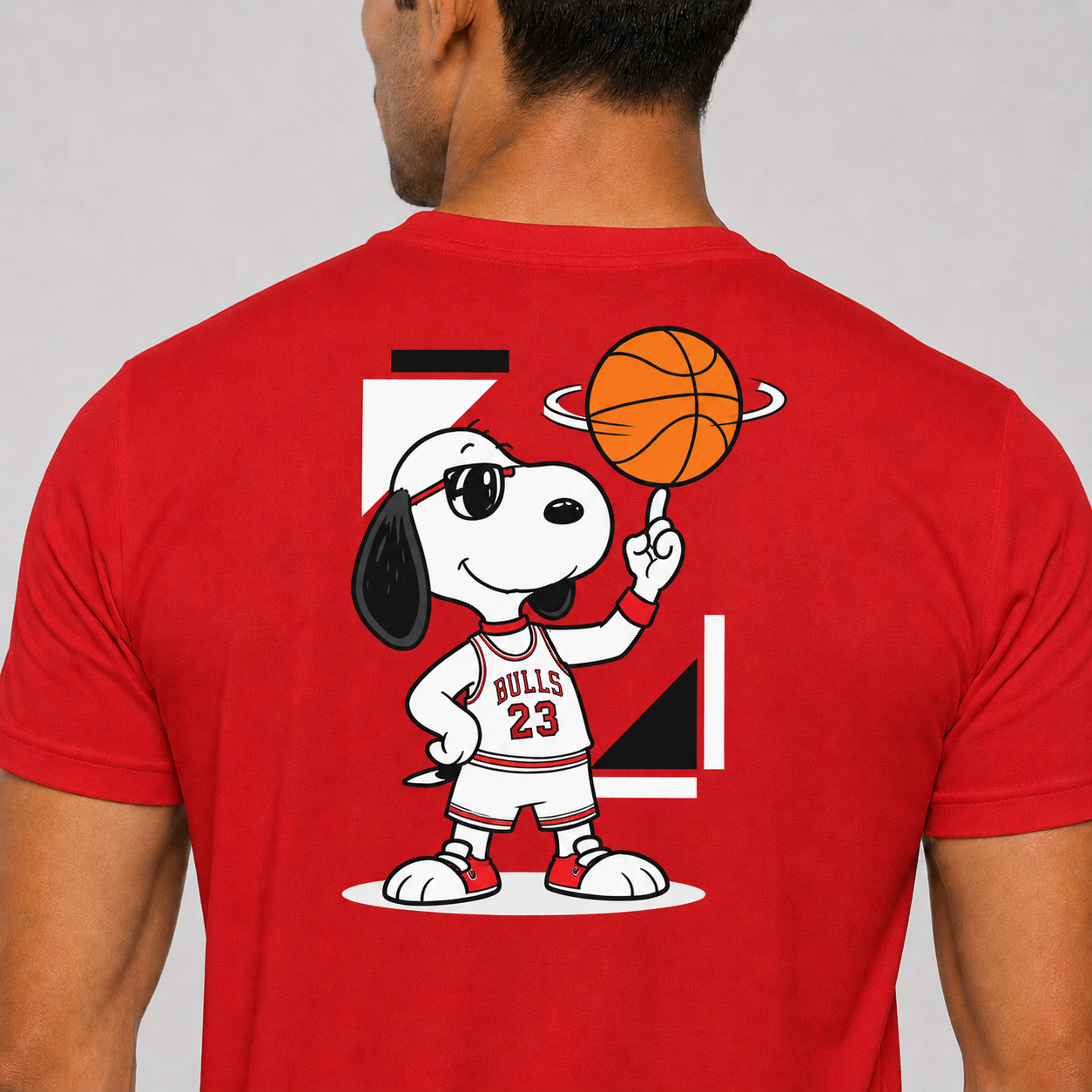 Red t-shirt with a cartoon character holding a basketball on the back, on a plain background.