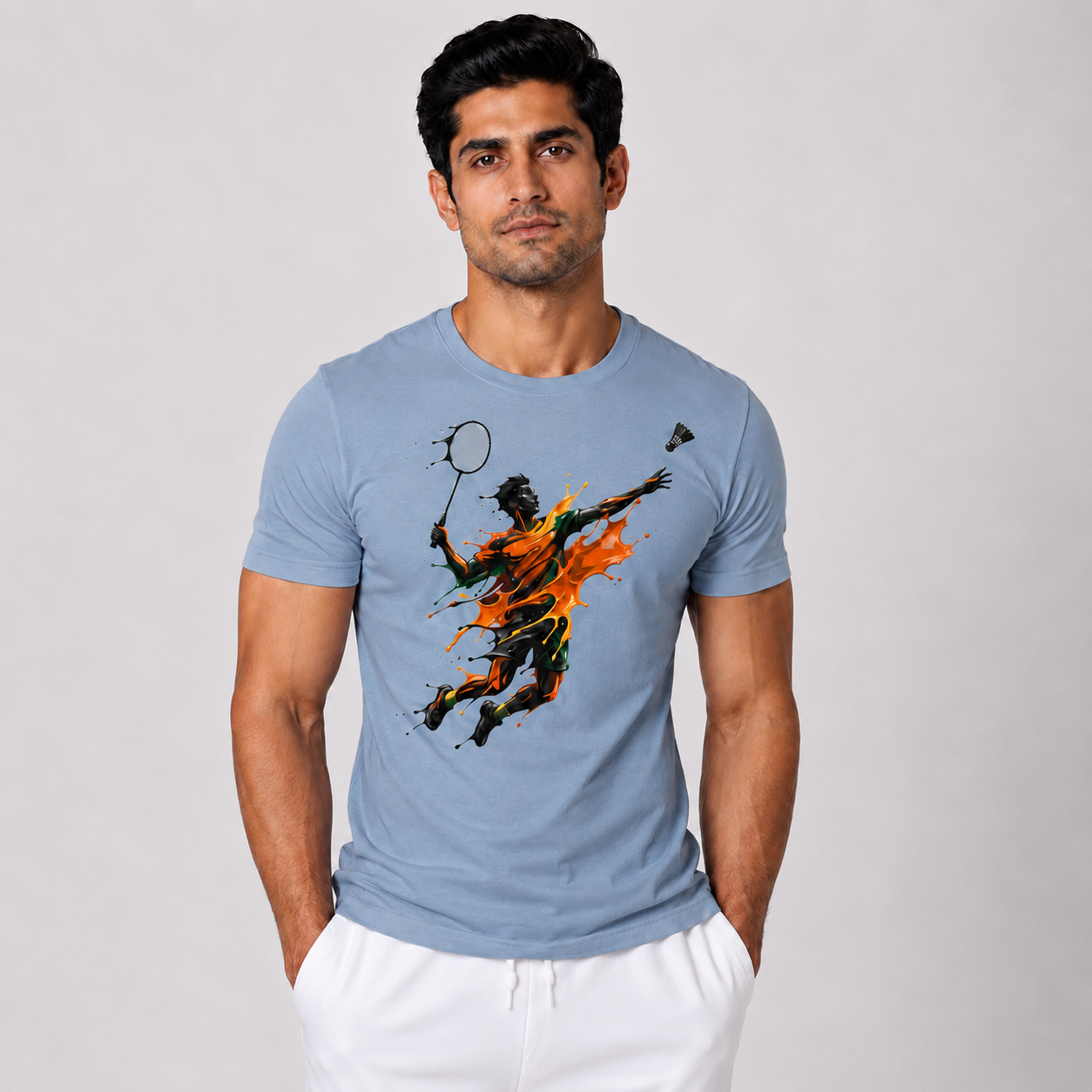 Man wearing a blue t-shirt with a graphic design of a badminton player.
