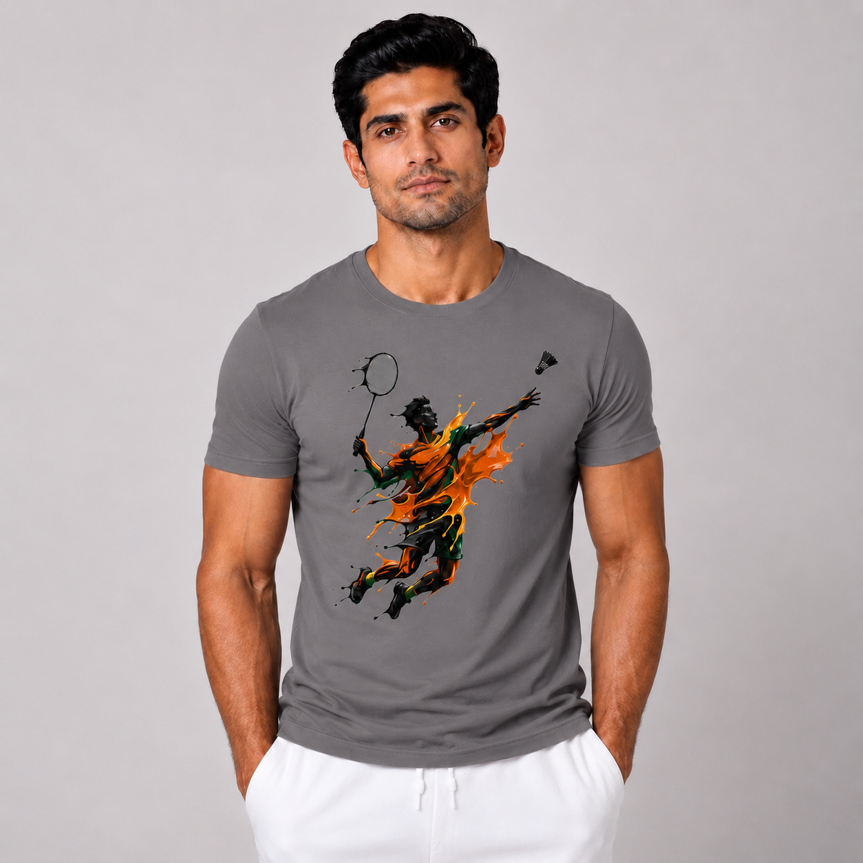 Man wearing a gray t-shirt with a graphic design on a plain background