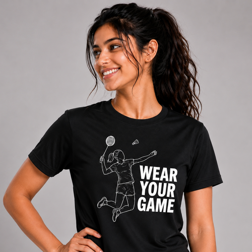 Woman wearing a black t-shirt with a graphic and text 'Wear Your Game' on a gray background