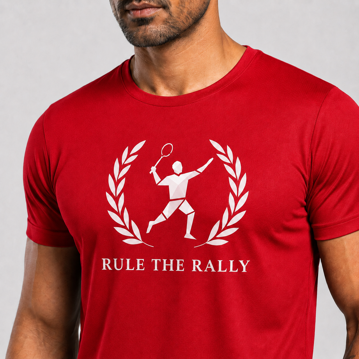 Red t-shirt with white graphic and text 'Rule the Rally' worn by a person on a gray background