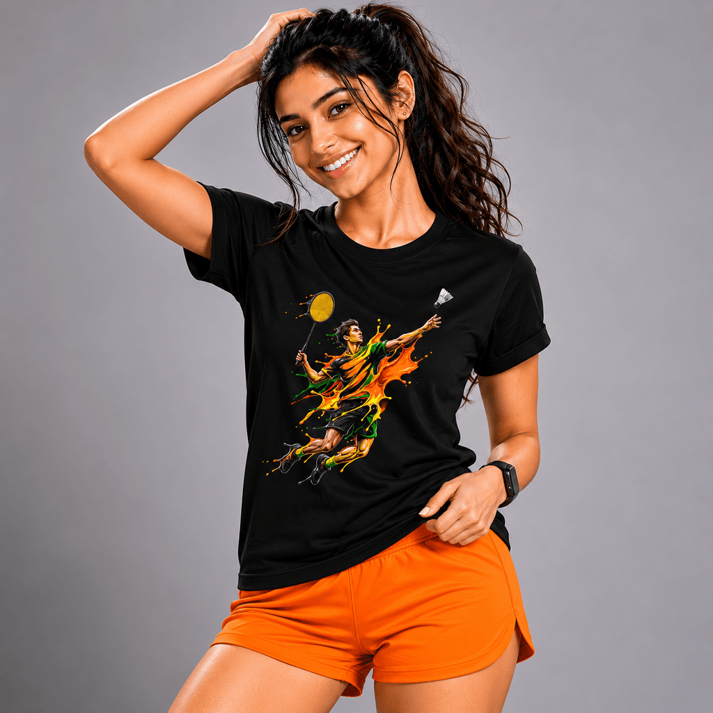 Woman wearing a black t-shirt with a colorful graphic design and orange shorts on a gray background