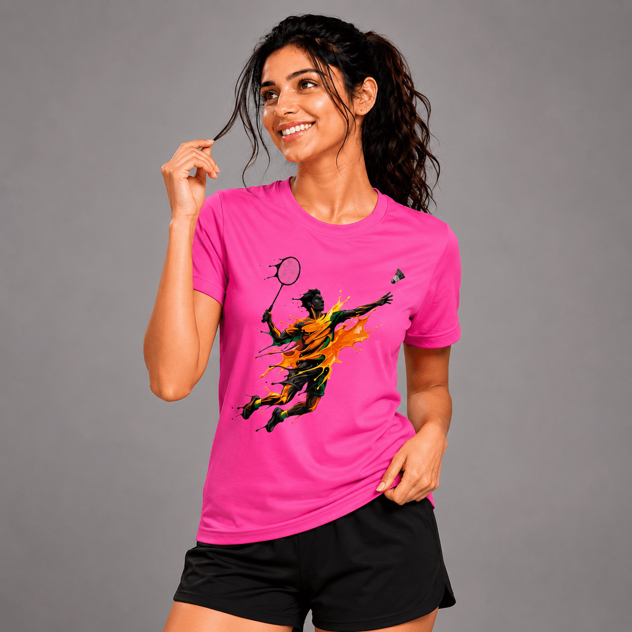 Woman wearing a pink t-shirt with a graphic design on a gray background