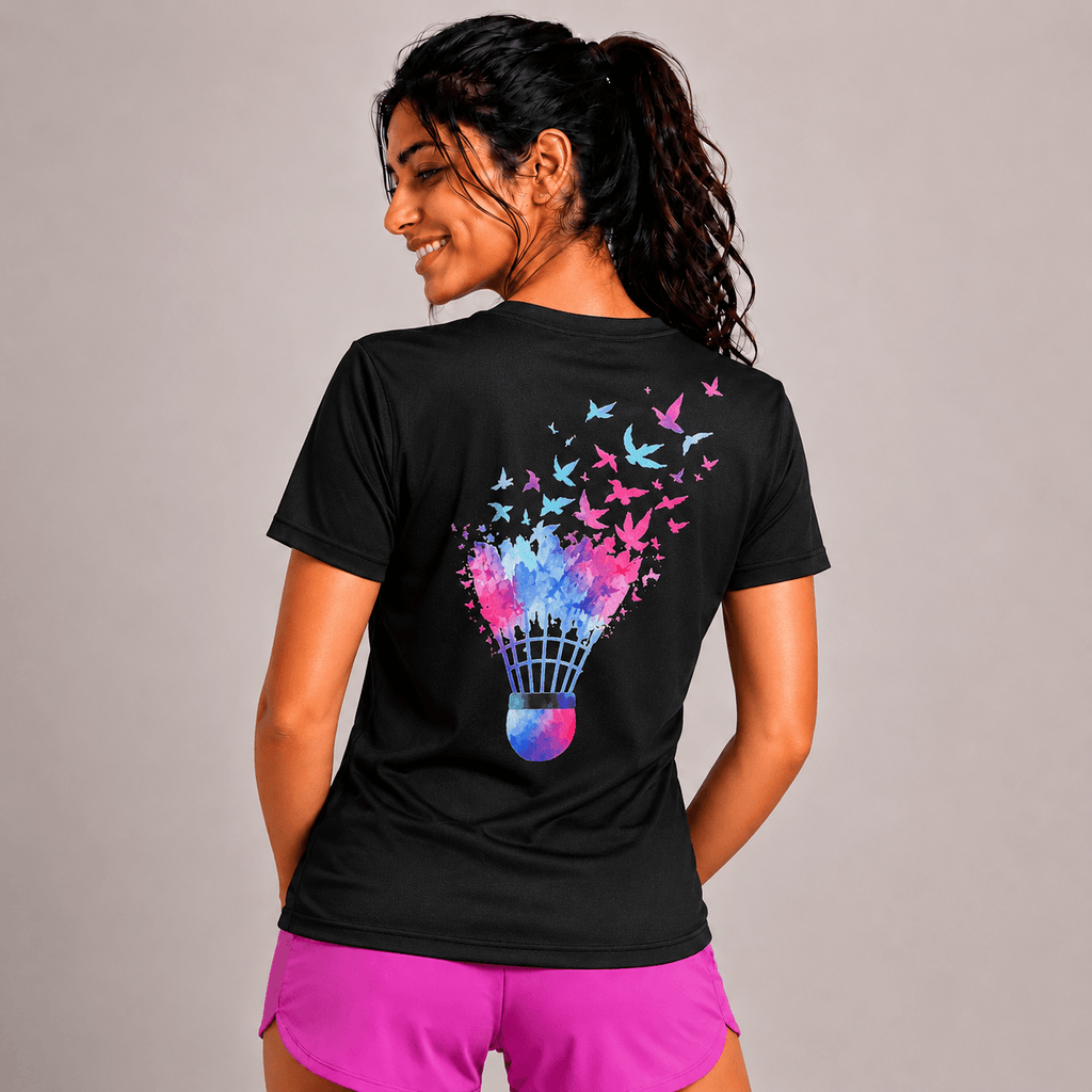 Woman wearing a black badminton t-shirt with a colorful graphic design on the back, standing against a plain background.