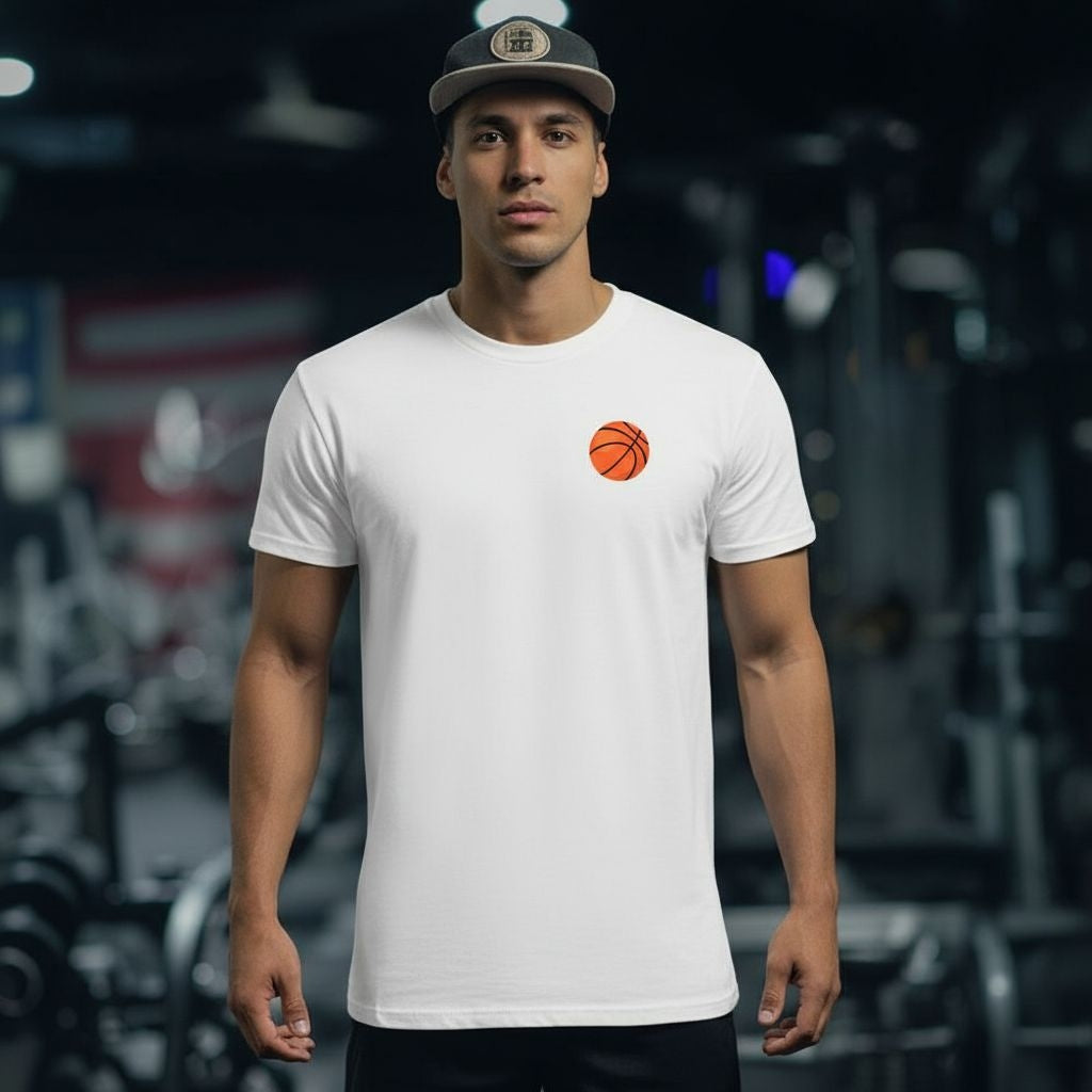 Man wearing a white t-shirt with a basketball graphic in a gym setting