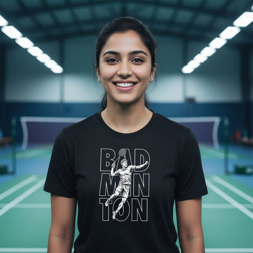 Woman wearing a black t-shirt with a badminton design on an indoor court